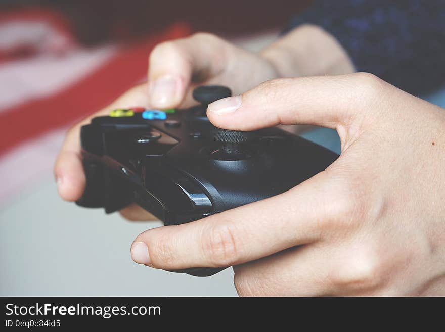 Man Holding Black Game Controller