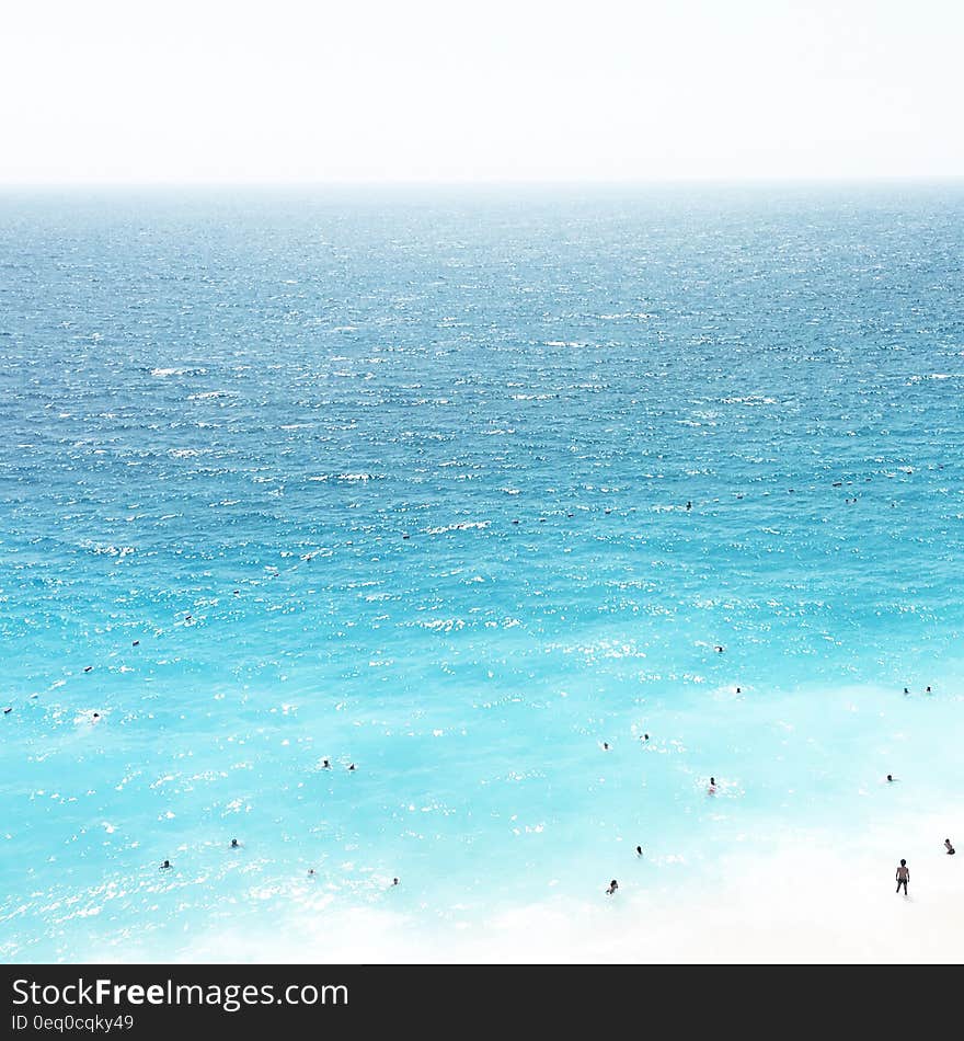 Blue seas and people swimming in the water.