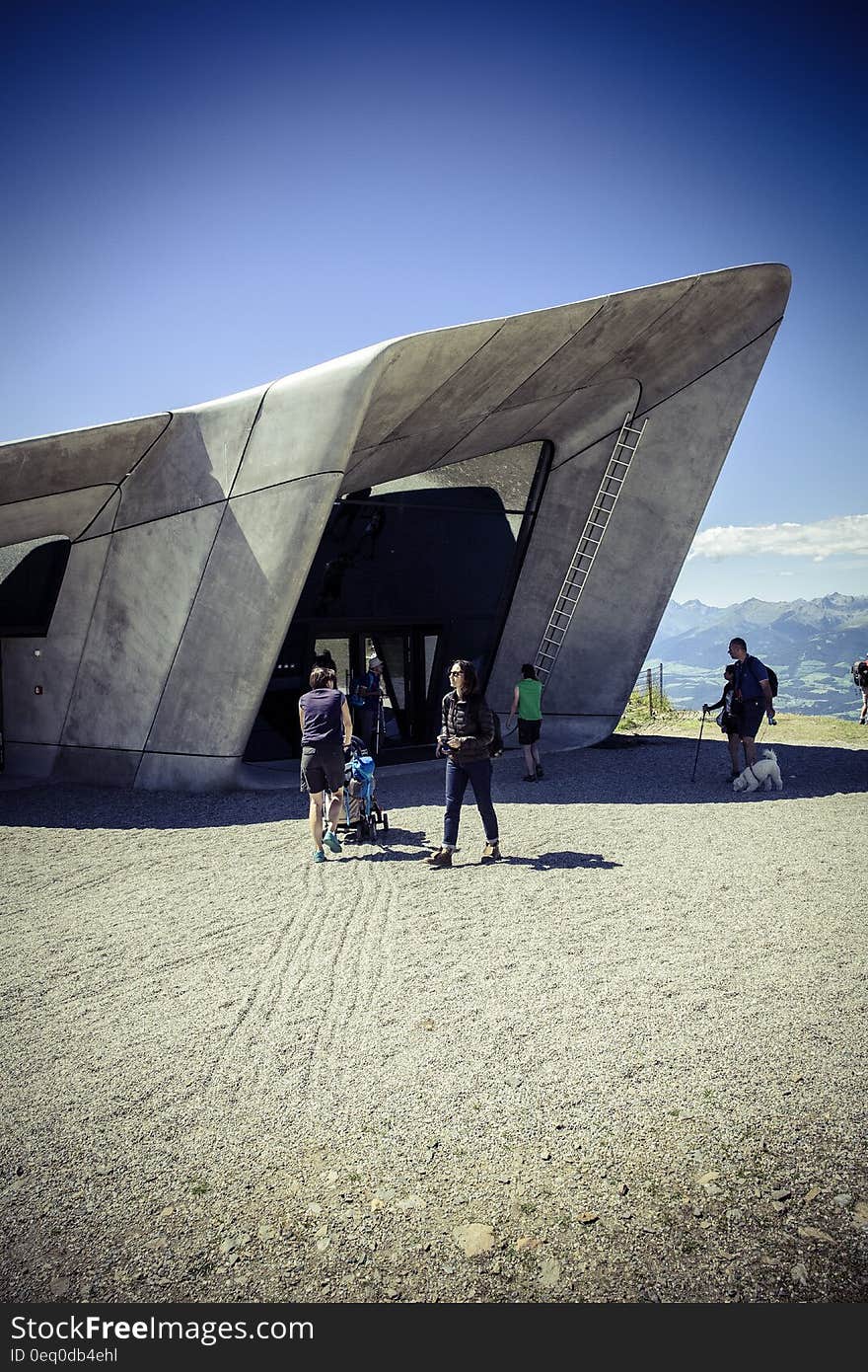 People standing outside museum in desert. People standing outside museum in desert.