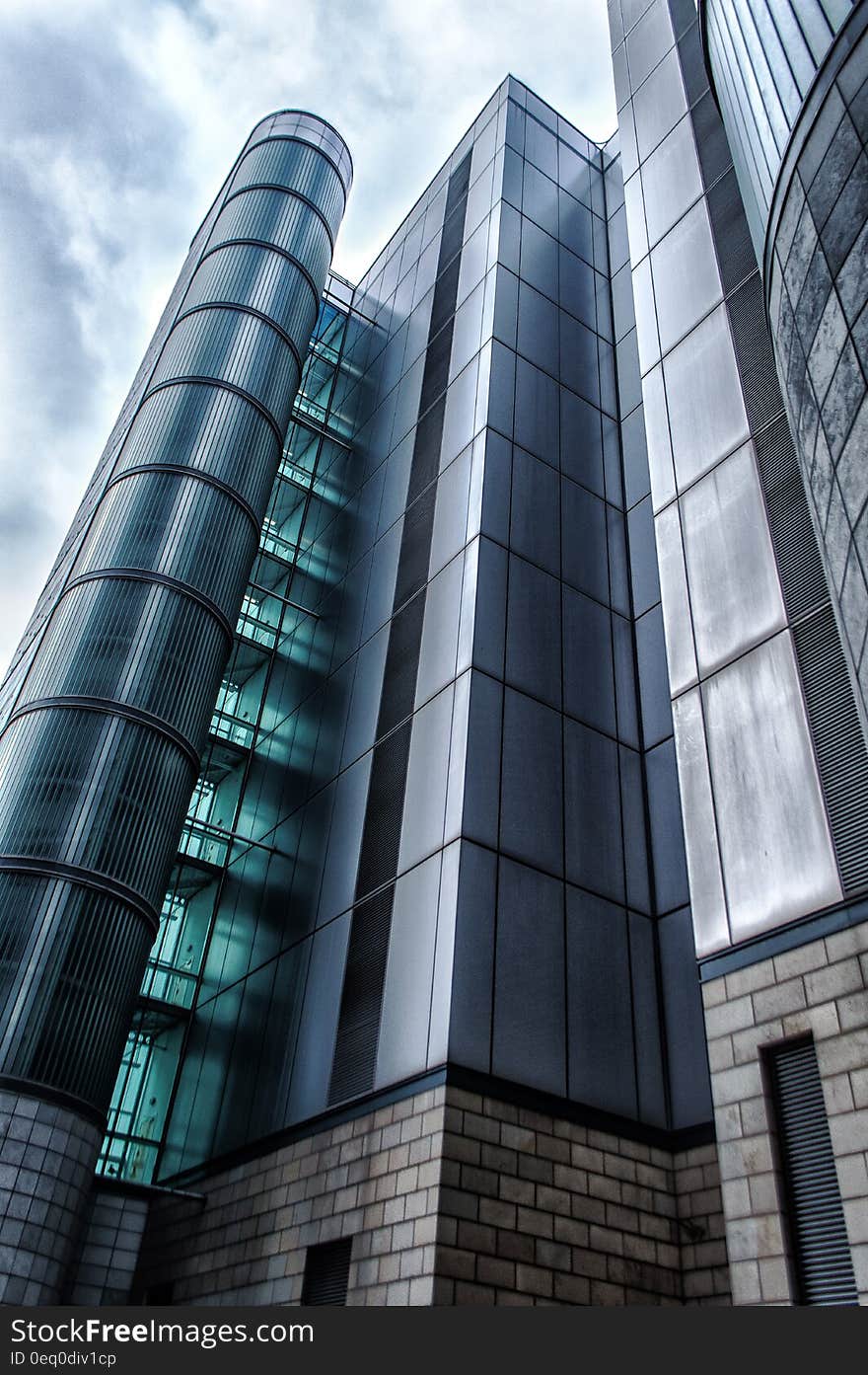 Low angle view looking to top of modern urban office building with glass exterior.