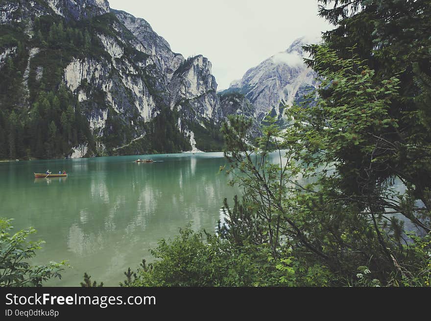 River Surrounded by Mountains during Daytime