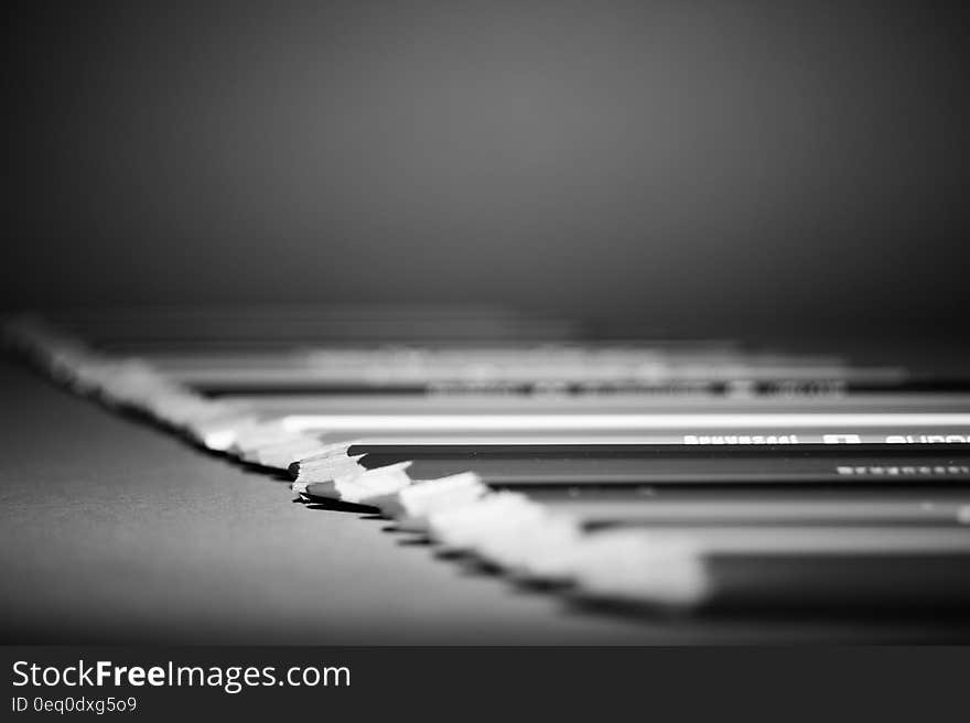 A row of color pencils in black and white. A row of color pencils in black and white.