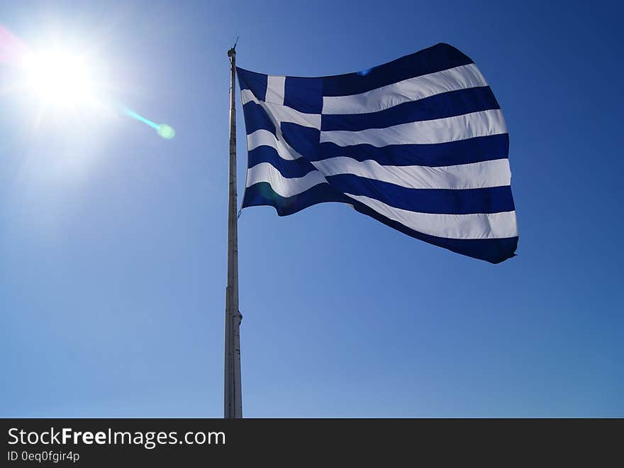 The flag of Greece flying against the blue skies. The flag of Greece flying against the blue skies.