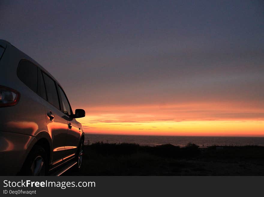 A car with the sunset skies on the background. A car with the sunset skies on the background.