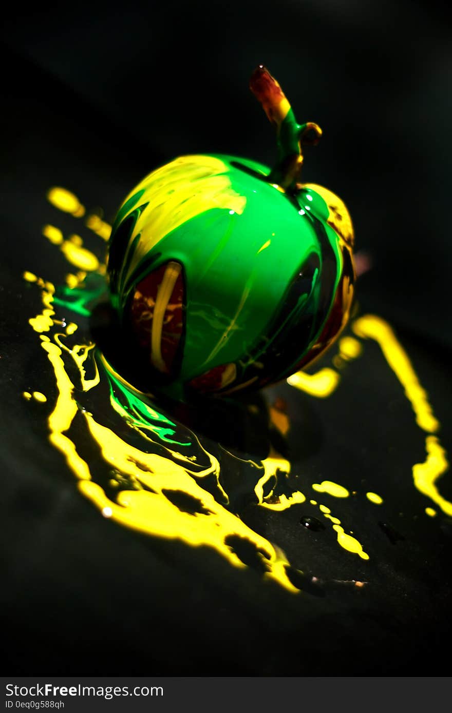 Abstract illustration of an apple in green and yellow colors surrounded by a black and yellow background. Abstract illustration of an apple in green and yellow colors surrounded by a black and yellow background.