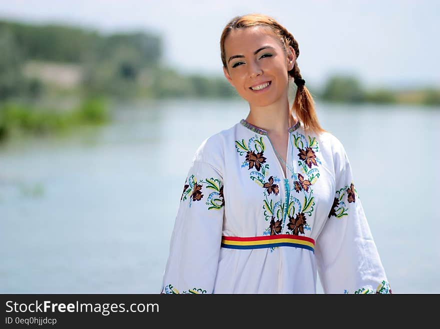 Woman in White Green and Red Floral V Neck Long Sleeve Dress