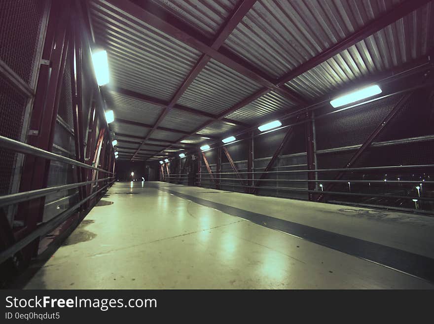 An empty lit footbridge at night. An empty lit footbridge at night.