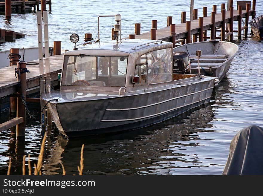 Product Photography of Silver Motor Boat Neck Dock during Daytime