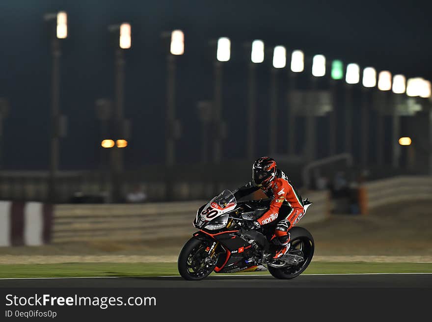 Person Riding Super Bike during Night Race