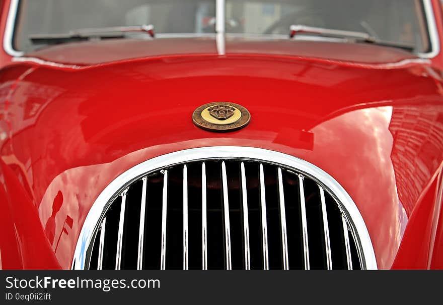 Red Car With Brown Emblem