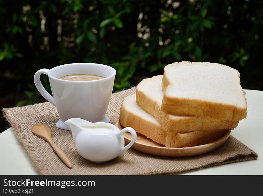 3 Sliced Loafs Beside White Ceramic Coffee Cup