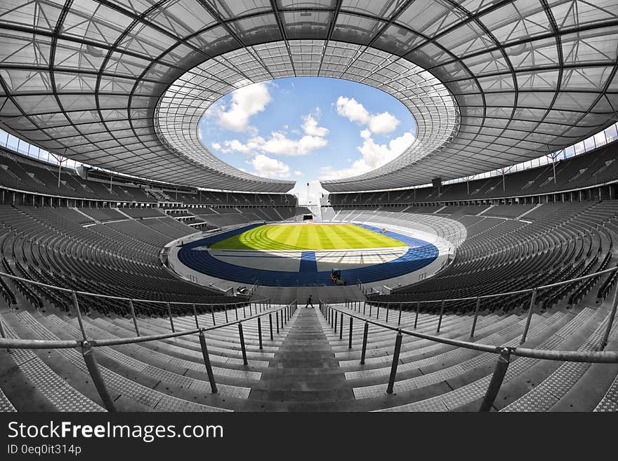 Selective Color Photography of Person at Soccer Stadium during Daytime