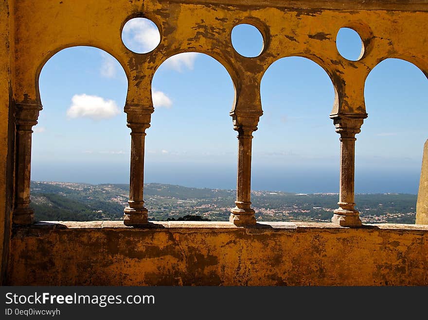 Grey Concrete 3 Baluster Near Mountains and Sea during Daytime