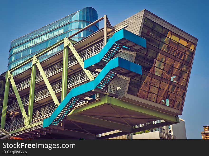 Brown Blue and Green Building With Blue Staircase