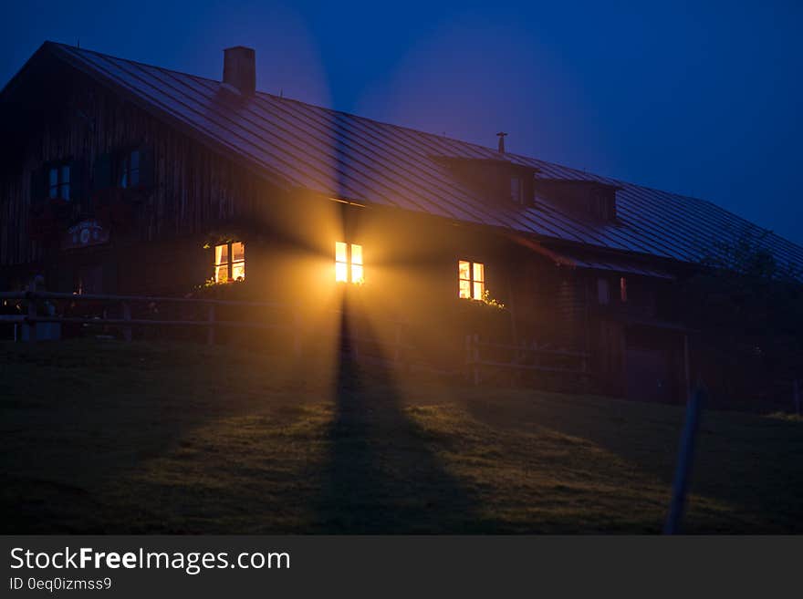 House With Orange Light during Night Time