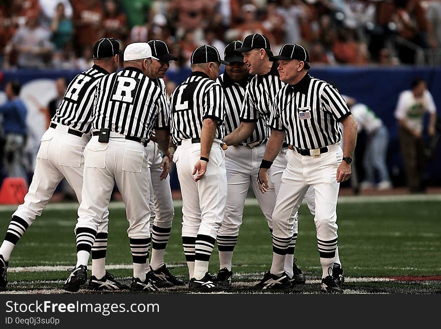 8 Football Referees in the Field