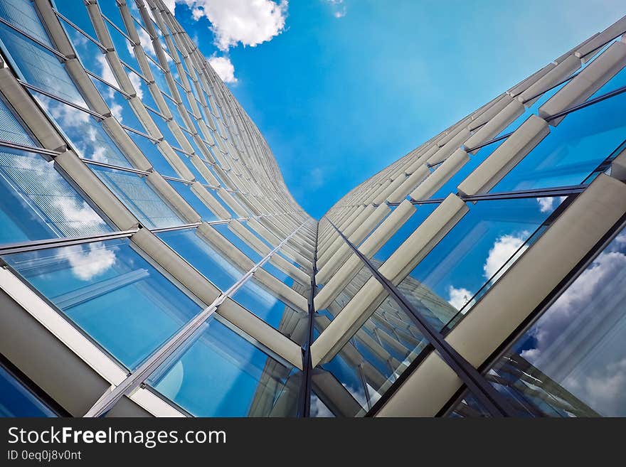 White Building Under Clear Blue Sky in Worms Eye View Photography