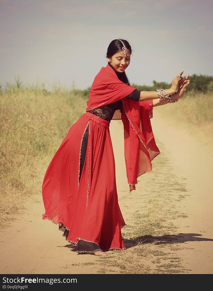 Woman in Red and Black 3/4 Sleeve Dress Dancing