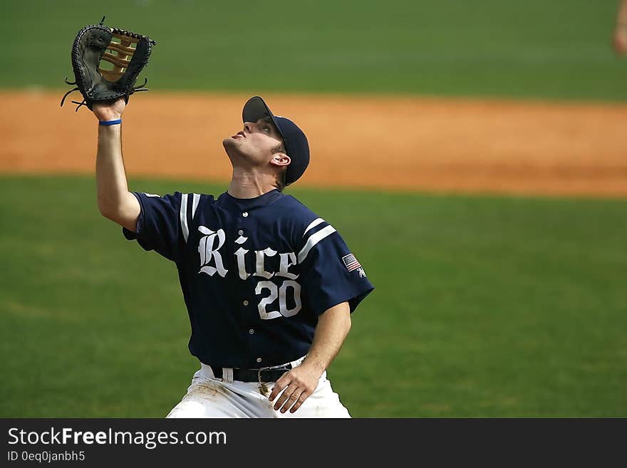 Man in Blue and White Rice 20 Jersey Looking Up during Daytime