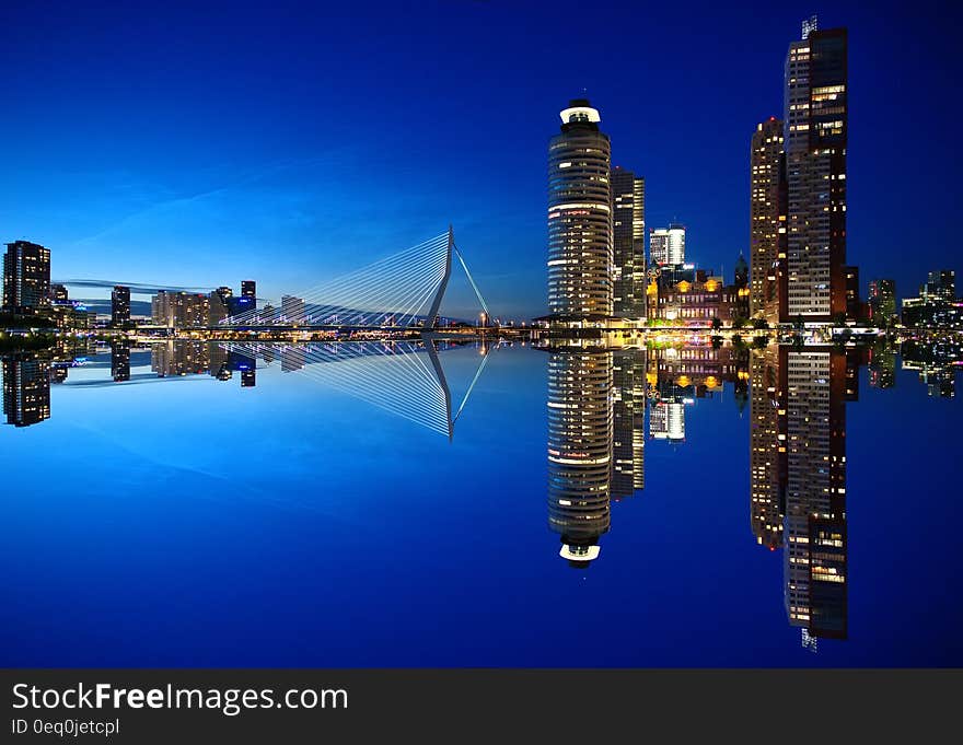 Mirrored Image of High Rise Buildings and Bridge