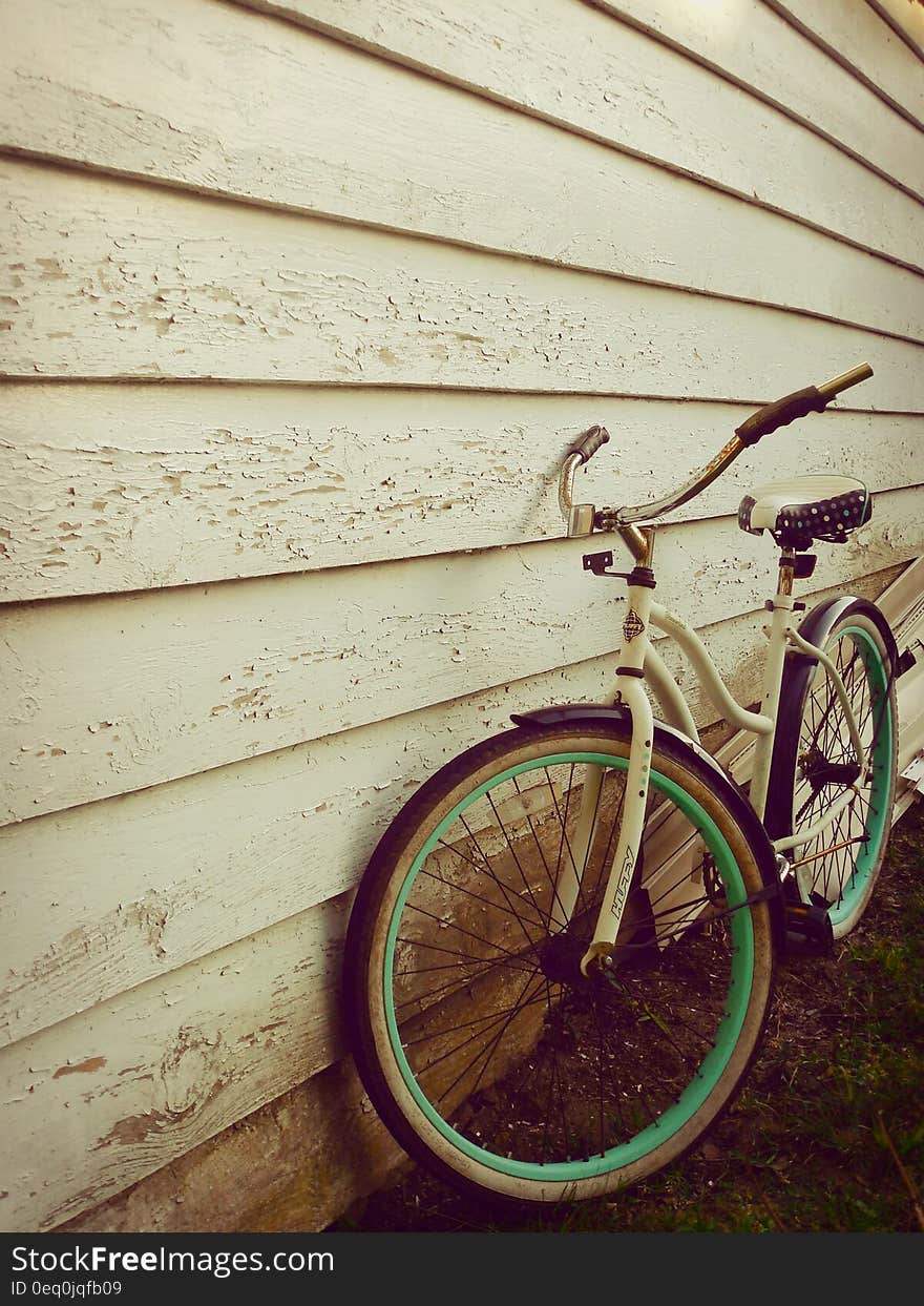 White and Teal Beach Cruiser Bike Beside White Painted Wooden Wall