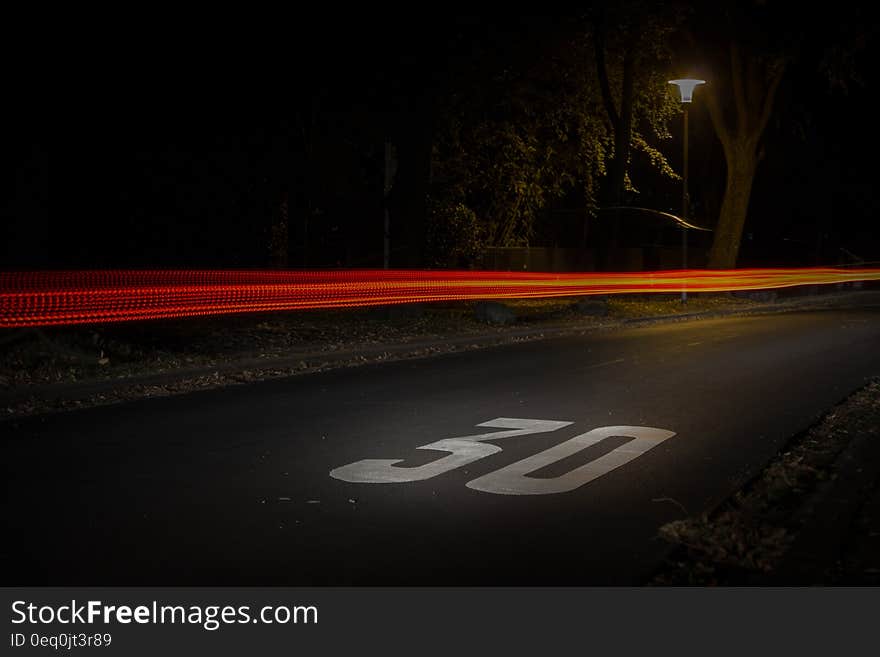 Time Lapse Photography of Red and Orange Light on Road With 30 Print on Nighttime