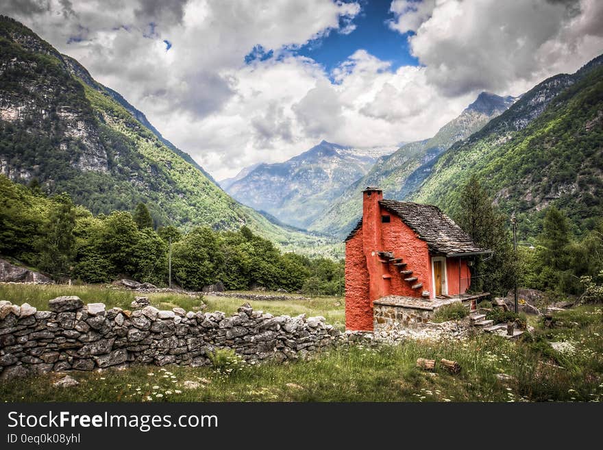 Brick House With Chimney in the Middle of Green Fields during Cloudy Day Photo