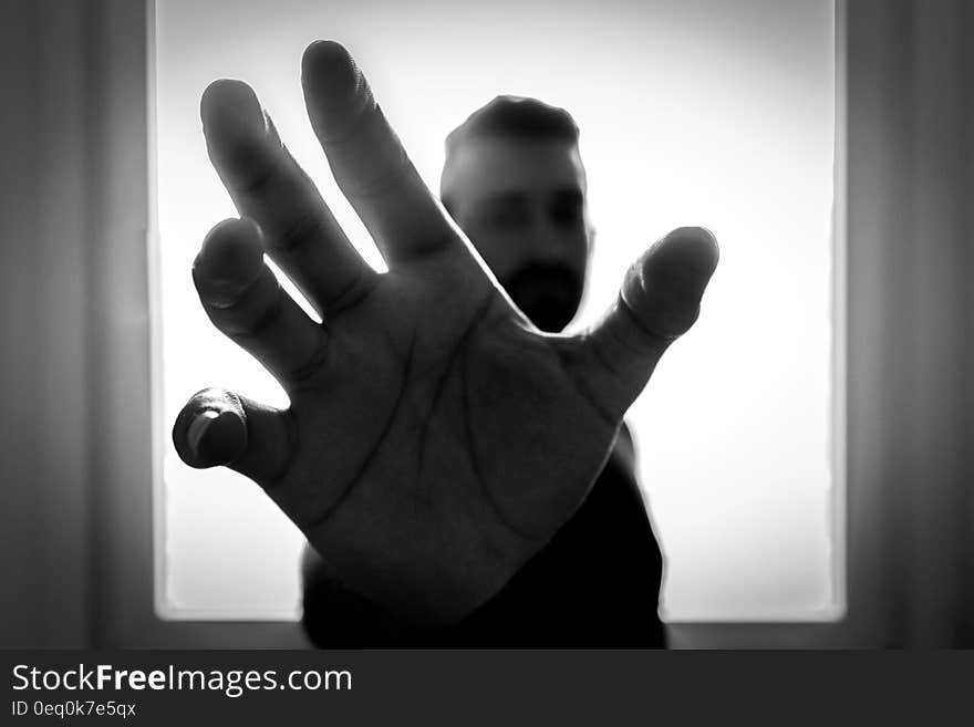 Grayscale Photo of Man Grabbing Using Right Hand