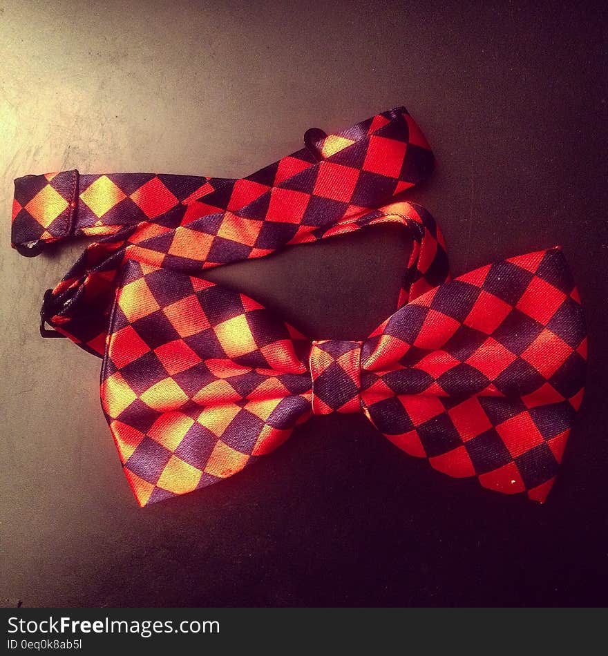 A checkered bow tie on dark background.