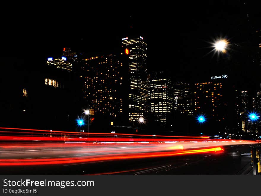 Time Lapse Photography of Red and Orange Taillight in City during Daytime