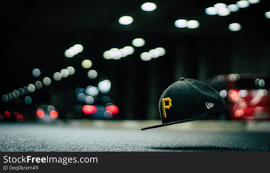 Black and Yellow P Cap Hanging in the Air