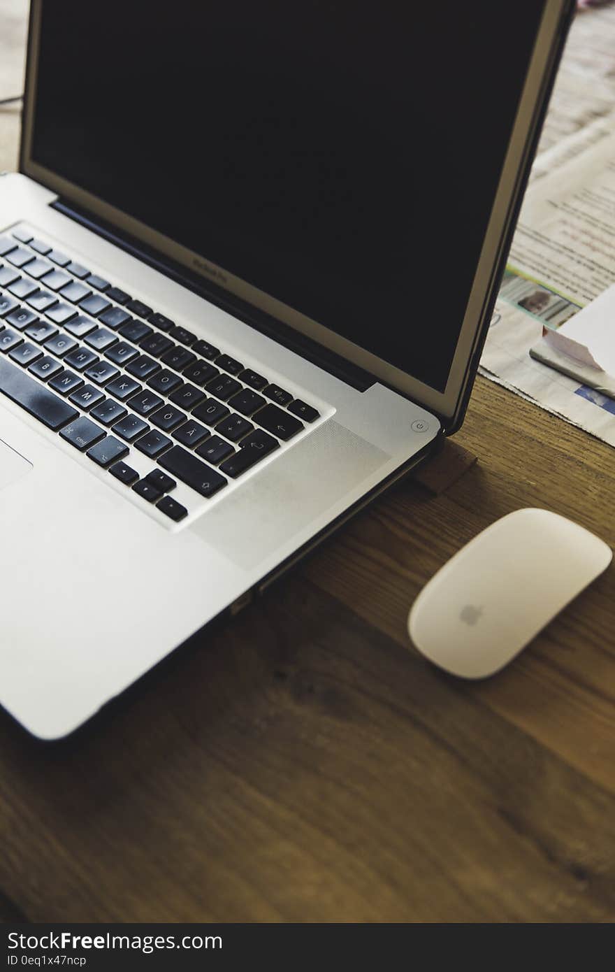 Macbook Pro Beside the Apple Magic Mouse