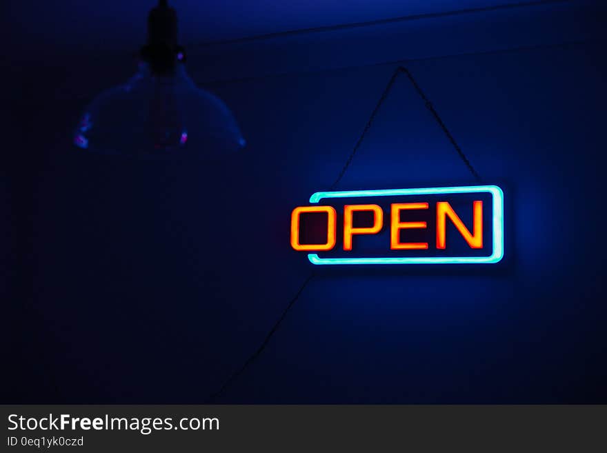 Yellow and Teal Open Neon Signage