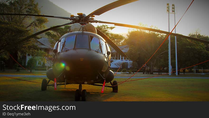 Black Chopper on Green Grass Lawn during Daytime