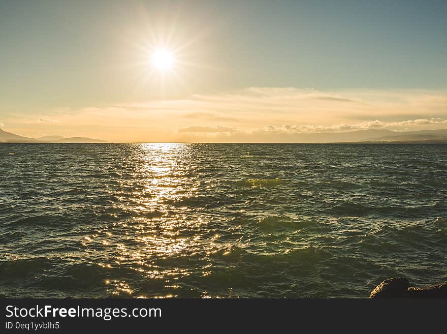 Green Sea Under Blue Sky during Day Time