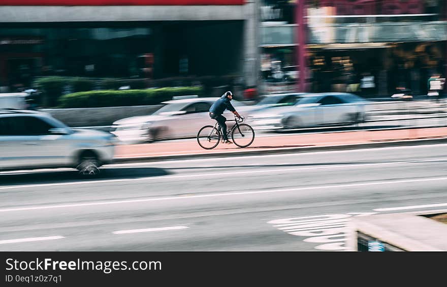 Man in Black Shirt Using Black Road Bicycle