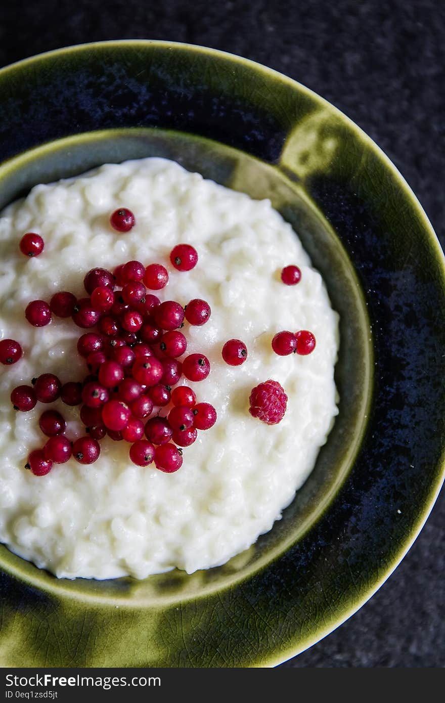 Red Cherry on White Soup Dish in Brown Plate