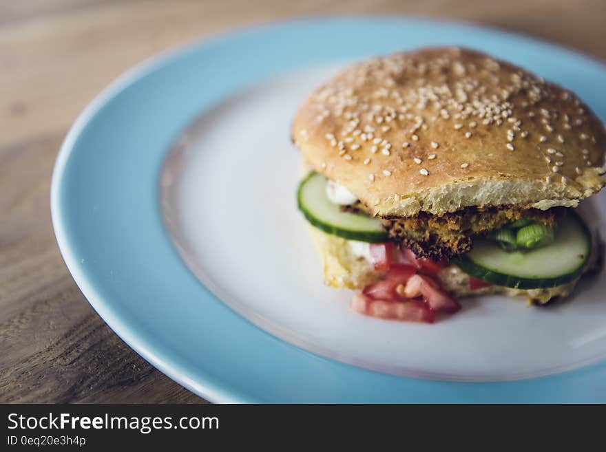 Bread With Sliced Green Vegetable and Meat on White and Blue Plate