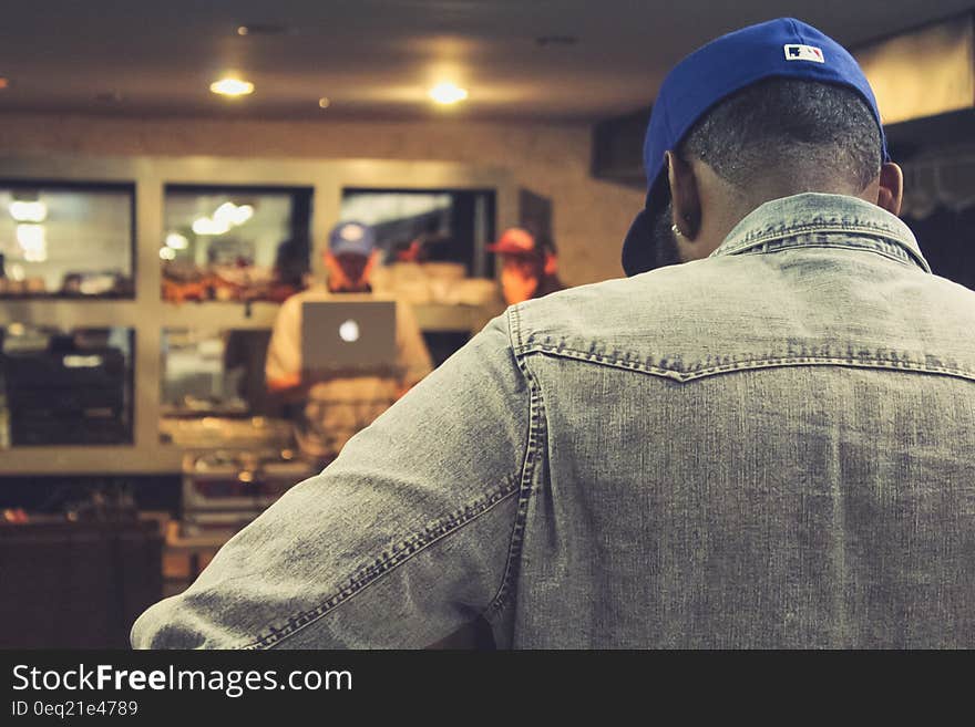 An African-American man standing in a cafe. An African-American man standing in a cafe.