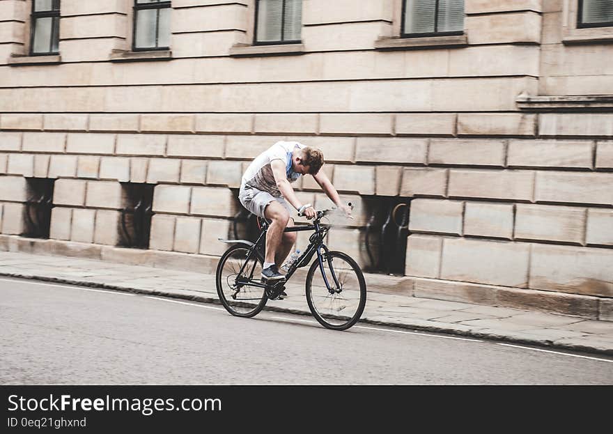 Man Riding Black Mountain Bike on Pathway during Daytime