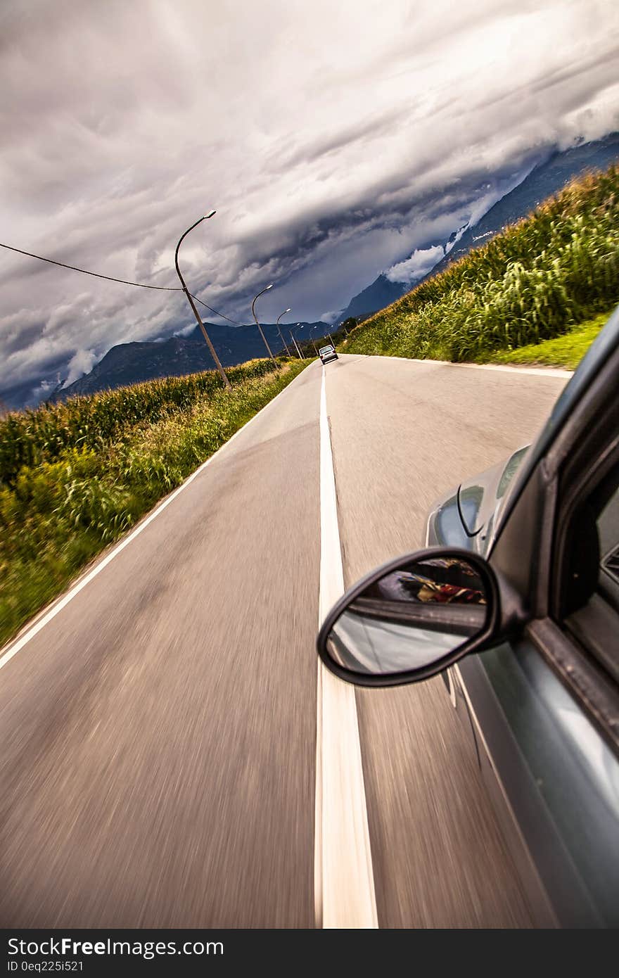 A car driving down a highway. A car driving down a highway.