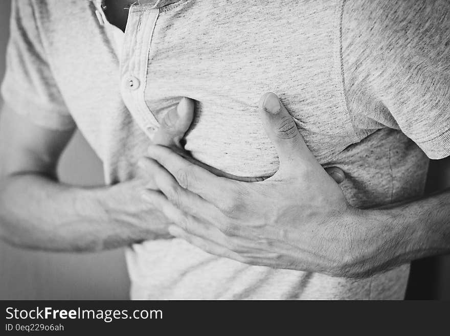 Man Wearing Polo Shirt Holding Left Chest