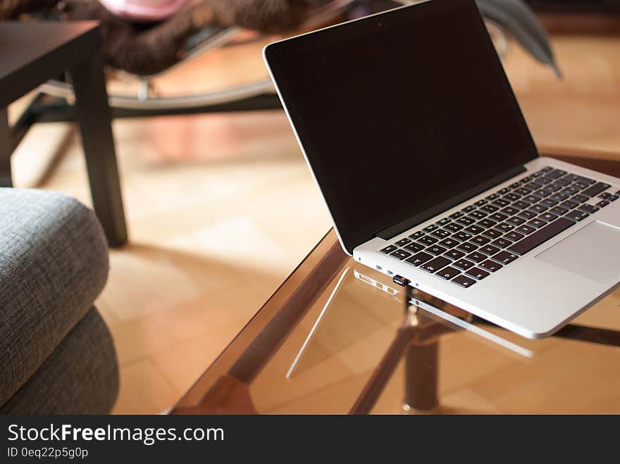 Black and Gray Laptop Computer on Glass Surface