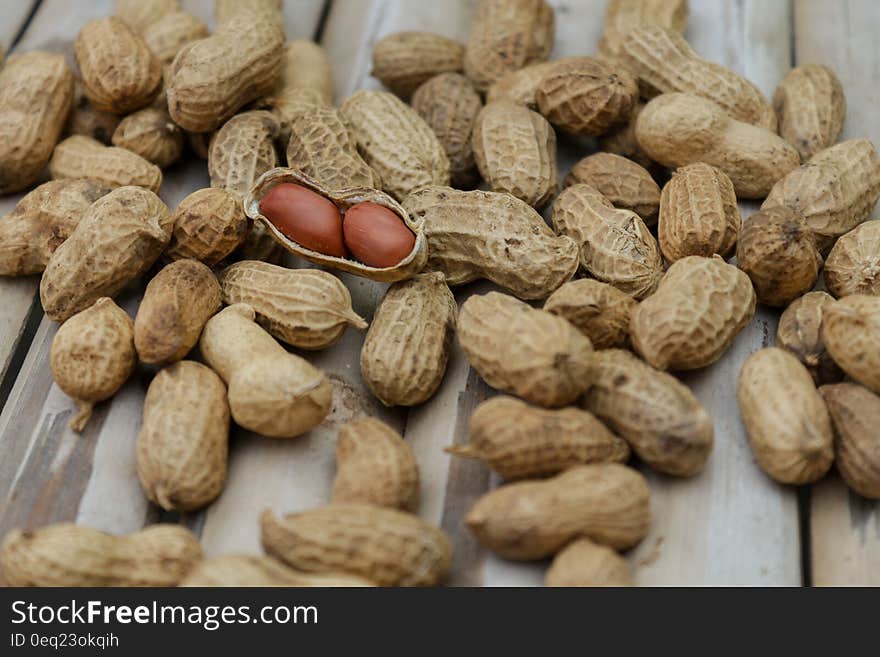 Roasted peanuts in shell on wooden boards. Roasted peanuts in shell on wooden boards.