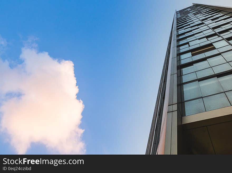 Facade of modern glass panel building against blue skies. Facade of modern glass panel building against blue skies.