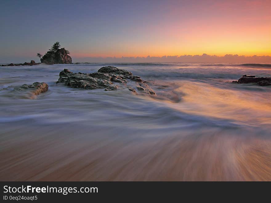 Blur of waves over sandy beach at dawn. Blur of waves over sandy beach at dawn.