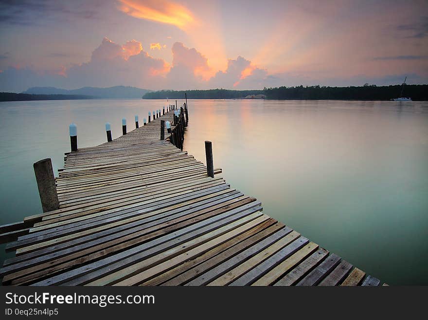 Wooden pier off coastline at sunset. Wooden pier off coastline at sunset.