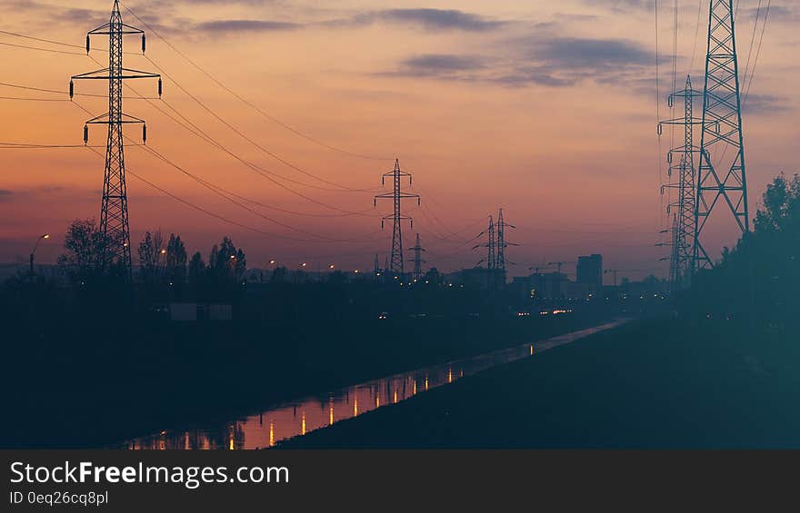 National grid power lines and pylons seen at sunset with a hint of atmospheric pollution close to edge of a city. National grid power lines and pylons seen at sunset with a hint of atmospheric pollution close to edge of a city.