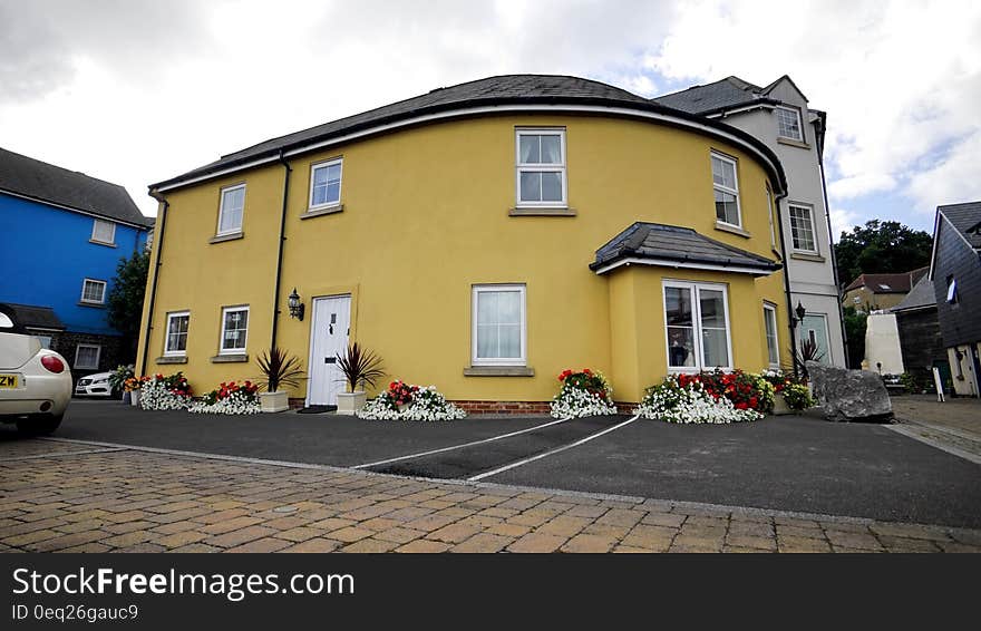 Exterior of bright yellow house in town.