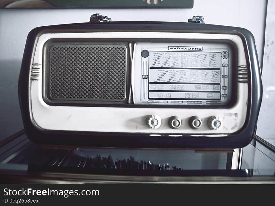 Vintage radio receiver on glass table.